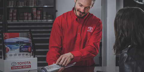 A Toyota Parts Advisor showing a windshield wiper part to a customer